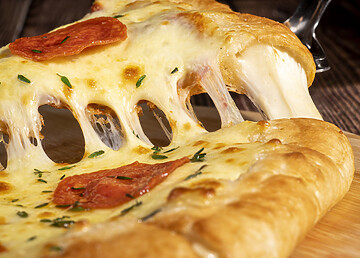 Cotati Food Service Server Lifting Slice Of Delicious Pepperoni Pizza With Melted Cheese